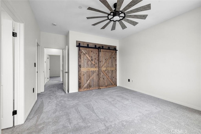 12039 Stanley Park Ct, Hawthorne, CA 90250 - unfurnished bedroom featuring carpet floors, a barn door, and a ceiling fan