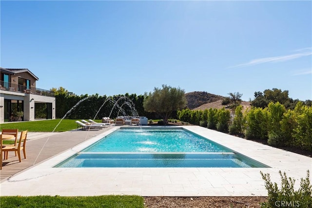 25151 Jim Bridger Rd, Hidden Hills, CA 91302 - view of pool featuring a patio area, a pool with connected hot tub, and a lawn