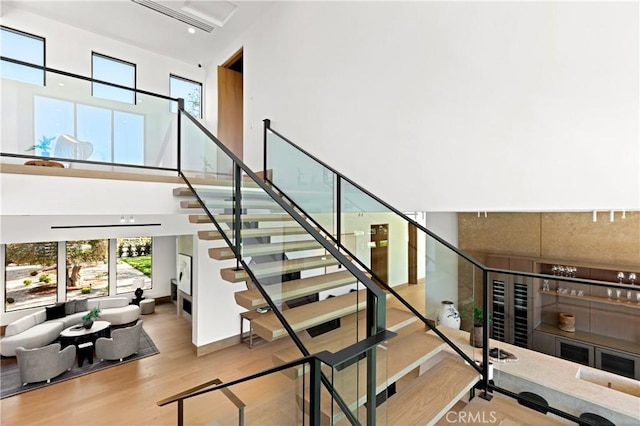 25151 Jim Bridger Rd, Hidden Hills, CA 91302 - stairway featuring wood finished floors and a towering ceiling