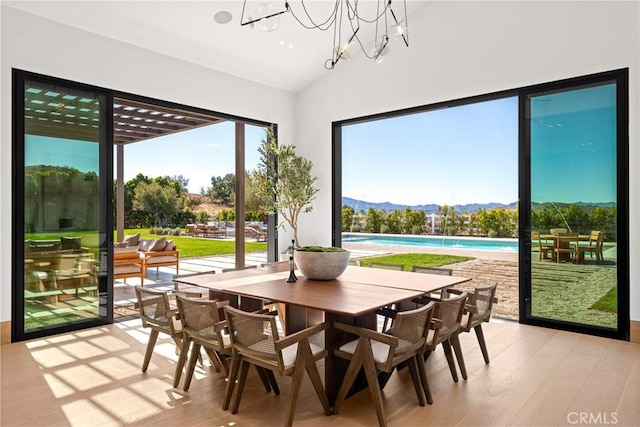 25151 Jim Bridger Rd, Hidden Hills, CA 91302 - dining room featuring a mountain view, lofted ceiling, light wood finished floors, and a chandelier