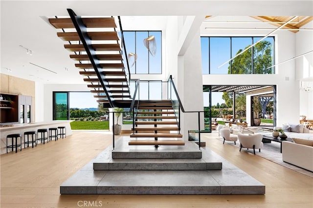 25151 Jim Bridger Rd, Hidden Hills, CA 91302 - stairway featuring wood finished floors and a high ceiling