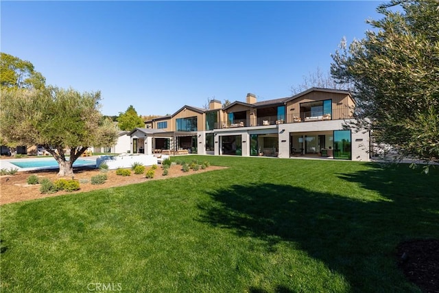 25151 Jim Bridger Rd, Hidden Hills, CA 91302 - rear view of property featuring a chimney, a lawn, a balcony, and a patio