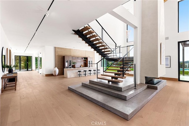 25151 Jim Bridger Rd, Hidden Hills, CA 91302 - stairway with hardwood / wood-style flooring and a high ceiling