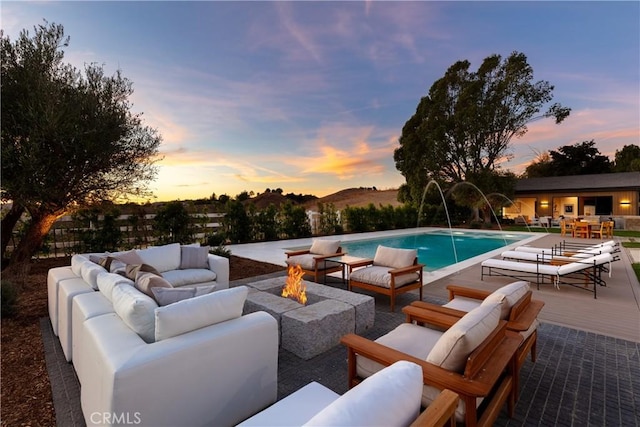 25151 Jim Bridger Rd, Hidden Hills, CA 91302 - outdoor pool with an outdoor living space with a fire pit, a wooden deck, and a patio area