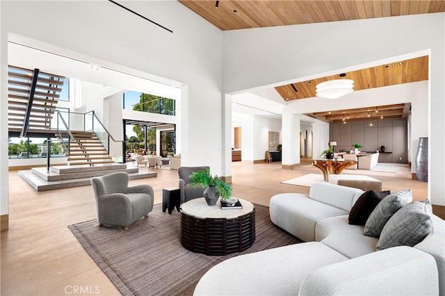 25151 Jim Bridger Rd, Hidden Hills, CA 91302 - living room with wooden ceiling, stairway, light wood-type flooring, and high vaulted ceiling