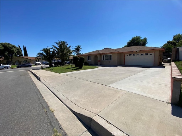 774 S Idyllwild Ave, Rialto, CA 92376 - single story home with an attached garage, concrete driveway, stucco siding, and a front lawn