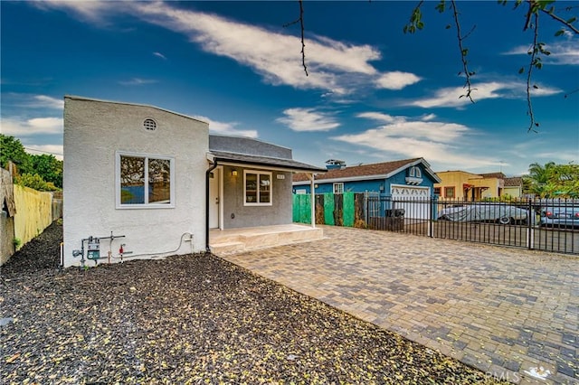 323 E 93rd St, Los Angeles, CA 90003 - back of property with stucco siding, a porch, and an outdoor structure