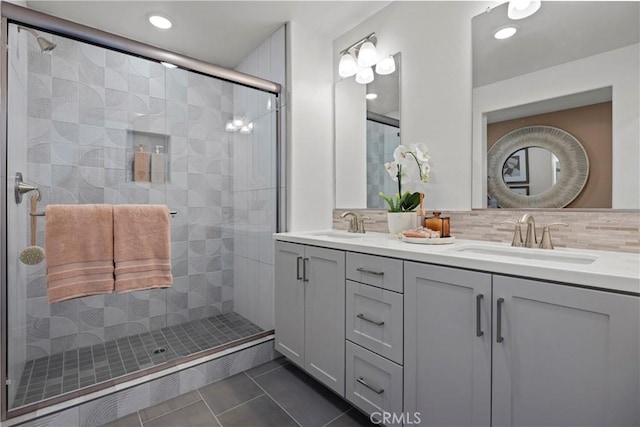 7348 Foster Bridge Blvd, Downey, CA 90240 - full bathroom featuring double vanity, a shower stall, backsplash, tile patterned flooring, and recessed lighting