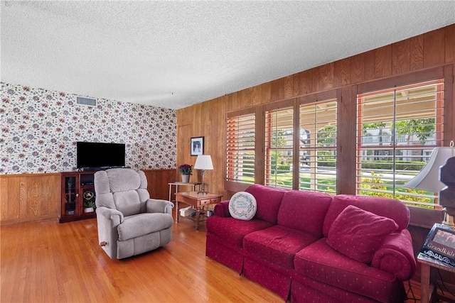 1419 S 4th Ave, Arcadia, CA 91006 - living area featuring healthy amount of natural light, a textured ceiling, wooden walls, wood finished floors, and wallpapered walls