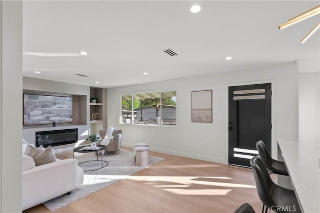 12934 Fenton Ave, Sylmar, CA 91342 - living area featuring wood finished floors, recessed lighting, and built in shelves