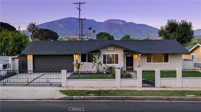 12934 Fenton Ave, Sylmar, CA 91342 - single story home featuring stucco siding, a garage, concrete driveway, a fenced front yard, and a mountain view