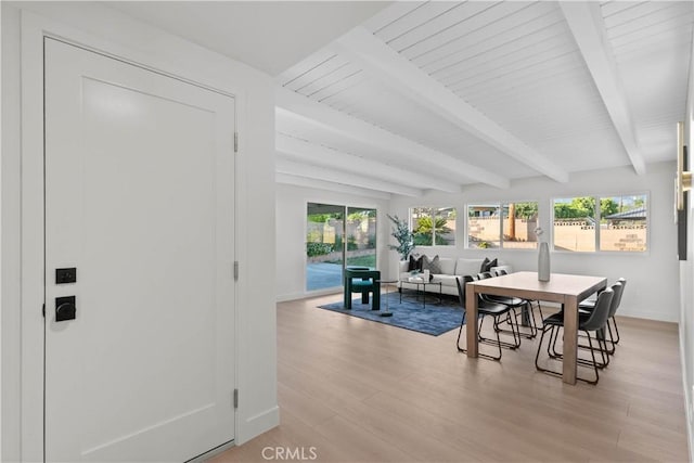 12934 Fenton Ave, Sylmar, CA 91342 - dining room featuring beamed ceiling, light wood-style flooring, and healthy amount of natural light