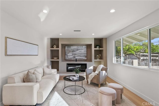 12934 Fenton Ave, Sylmar, CA 91342 - living room with wood finished floors, recessed lighting, built in shelves, and a glass covered fireplace