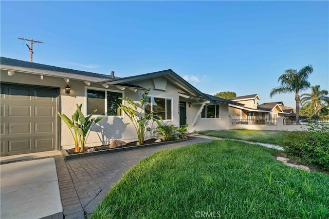 12934 Fenton Ave, Sylmar, CA 91342 - single story home with stucco siding, an attached garage, and a front lawn