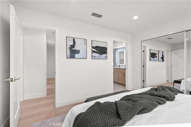 12934 Fenton Ave, Sylmar, CA 91342 - bedroom with light wood-style flooring, recessed lighting, and ensuite bath