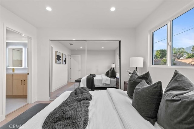 12934 Fenton Ave, Sylmar, CA 91342 - bedroom with recessed lighting, light wood-style flooring, a closet, and connected bathroom