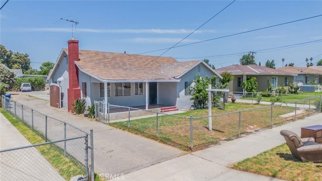 1455 S Towne Ave, Pomona, CA 91766 - single story home featuring a fenced front yard, stucco siding, a gate, roof with shingles, and a chimney