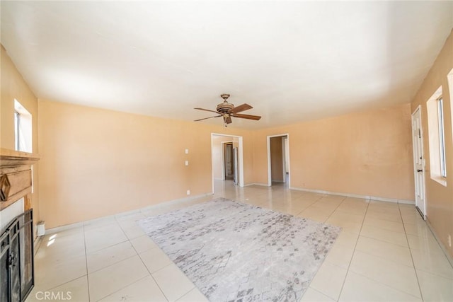 1455 S Towne Ave, Pomona, CA 91766 - unfurnished living room featuring light tile patterned floors, ceiling fan, and a fireplace