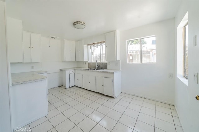 1455 S Towne Ave, Pomona, CA 91766 - kitchen with white cabinetry, light countertops, and light tile patterned floors