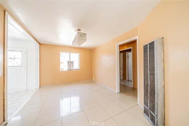 1455 S Towne Ave, Pomona, CA 91766 - unfurnished room with a heating unit and light tile patterned floors