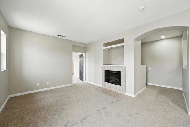 2755 Castlehill Rd Unit 1, Chula Vista, CA 91915 - unfurnished living room featuring carpet, arched walkways, and a tile fireplace