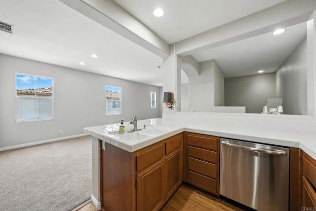 2755 Castlehill Rd Unit 1, Chula Vista, CA 91915 - kitchen with stainless steel dishwasher, brown cabinets, recessed lighting, open floor plan, and carpet flooring