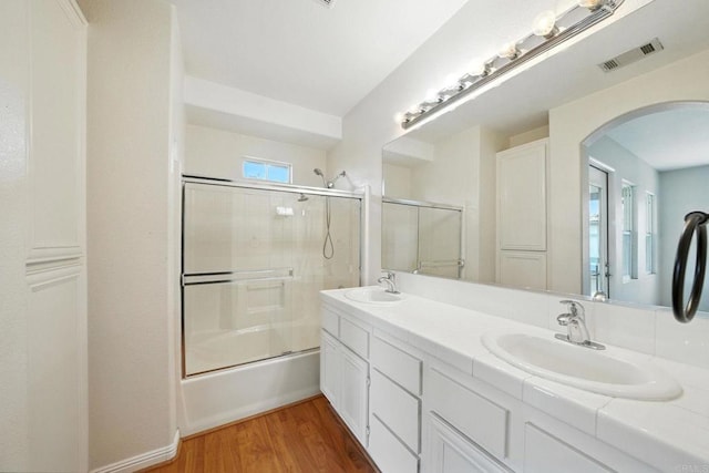 2755 Castlehill Rd Unit 1, Chula Vista, CA 91915 - bathroom featuring double vanity, bath / shower combo with glass door, and wood finished floors