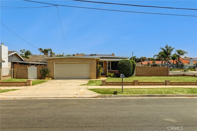 4523 Columbia Ave, Riverside, CA 92501 - view of front of home featuring concrete driveway, a garage, and stucco siding