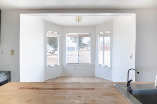 9018 Buckthorn Ave, Hesperia, CA 92345 - unfurnished dining area with a sink and tile patterned flooring