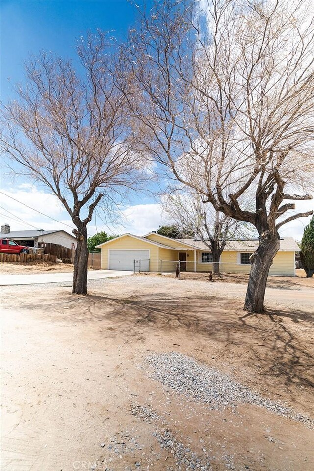 9018 Buckthorn Ave, Hesperia, CA 92345 - view of front of property with dirt driveway and a garage