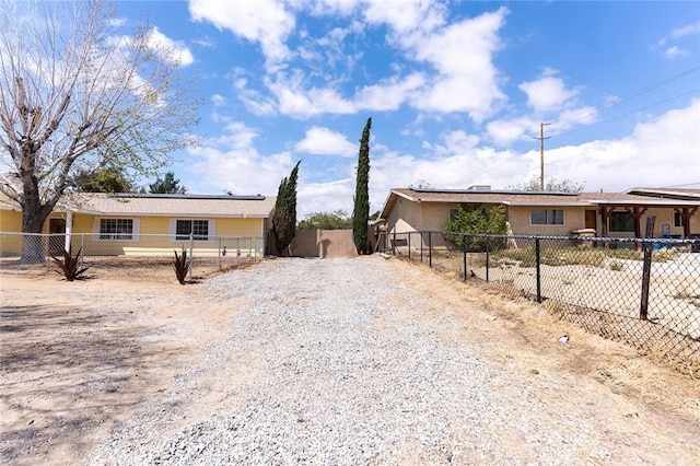 9018 Buckthorn Ave, Hesperia, CA 92345 - view of front facade with driveway, solar panels, and a gate