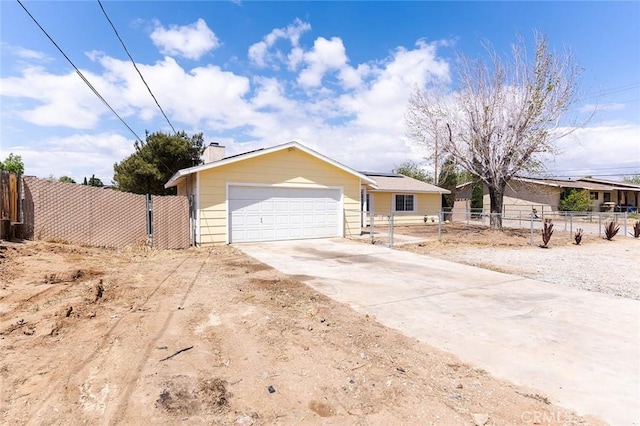 9018 Buckthorn Ave, Hesperia, CA 92345 - view of front of home with a fenced front yard, solar panels, a chimney, concrete driveway, and a garage