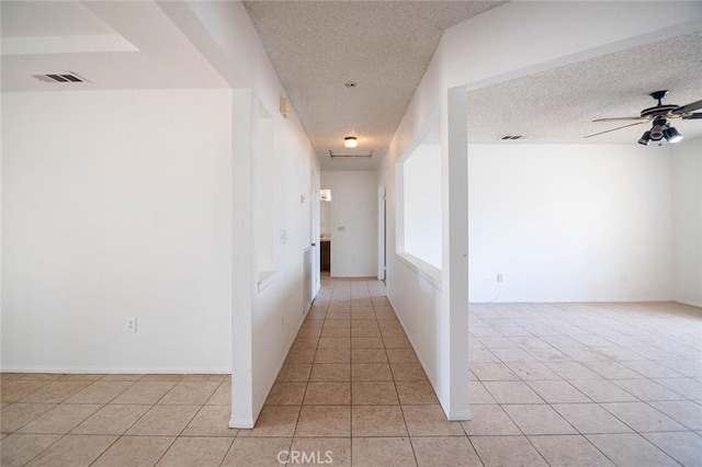 9018 Buckthorn Ave, Hesperia, CA 92345 - hall featuring a textured ceiling and light tile patterned flooring
