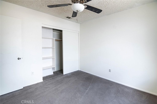 9018 Buckthorn Ave, Hesperia, CA 92345 - unfurnished bedroom with dark colored carpet, a closet, a textured ceiling, and ceiling fan