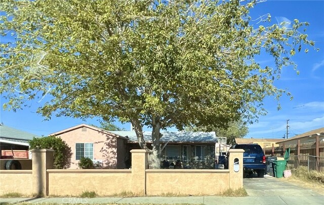 45040 Redwood Ave, Lancaster, CA 93534 - ranch-style home with a fenced front yard, concrete driveway, and stucco siding