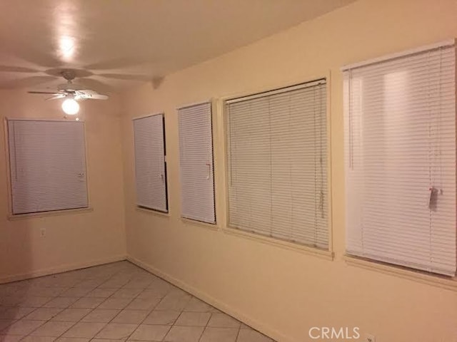 45040 Redwood Ave, Lancaster, CA 93534 - empty room with a ceiling fan and light tile patterned flooring