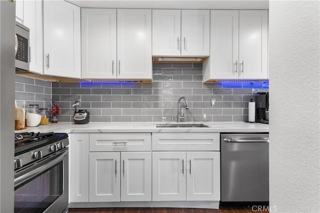 31319 The Old Rd Unit A, Castaic, CA 91384 - kitchen with appliances with stainless steel finishes, white cabinetry, decorative backsplash, and light stone countertops