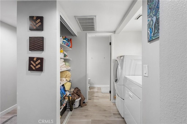 31319 The Old Rd Unit A, Castaic, CA 91384 - laundry room featuring washing machine and clothes dryer and light wood-style floors