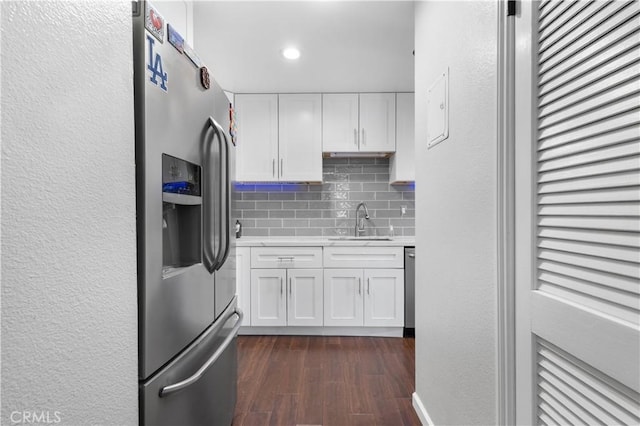 31319 The Old Rd Unit A, Castaic, CA 91384 - kitchen with stainless steel fridge, light countertops, tasteful backsplash, white cabinetry, and a textured wall