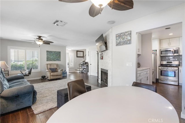 31319 The Old Rd Unit A, Castaic, CA 91384 - dining area featuring ceiling fan, dark wood finished floors, and a fireplace