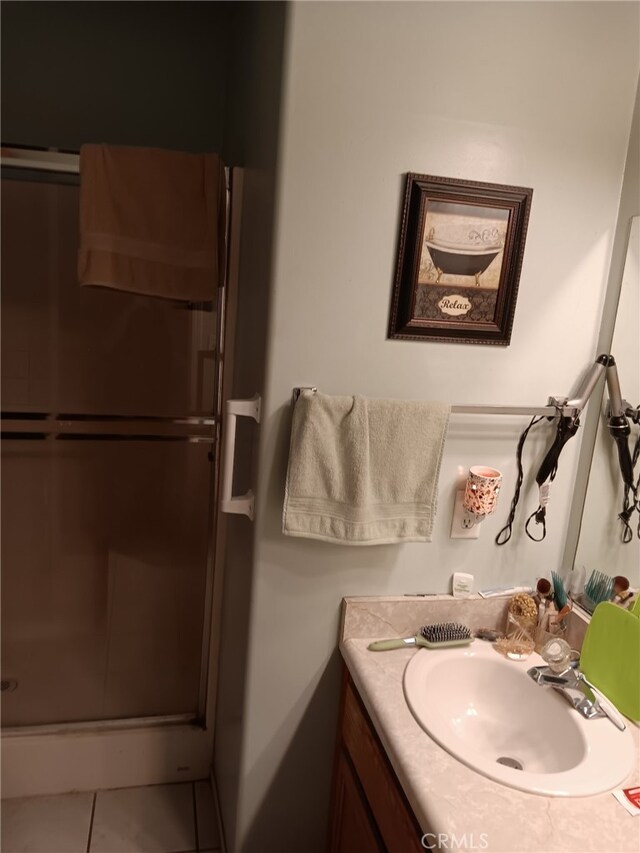 412 Leeta St, Bakersfield, CA 93307 - full bathroom with vanity, a stall shower, and tile patterned floors