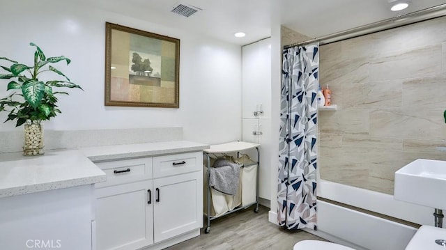 10361 Perdido St, Anaheim, CA 92804 - full bathroom featuring vanity, shower / tub combo with curtain, wood finished floors, and recessed lighting
