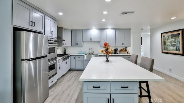 10361 Perdido St, Anaheim, CA 92804 - kitchen featuring stainless steel appliances, gray cabinets, light wood-type flooring, light countertops, and recessed lighting
