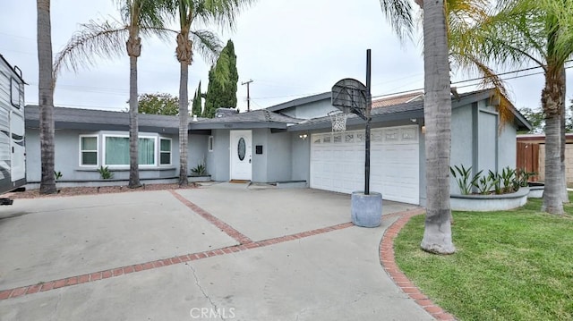10361 Perdido St, Anaheim, CA 92804 - view of front facade with stucco siding, concrete driveway, an attached garage, and a front lawn