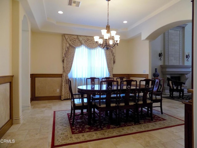 4526 Katherine Ave, Sherman Oaks, CA 91423 - dining room with arched walkways, a tray ceiling, a chandelier, and recessed lighting