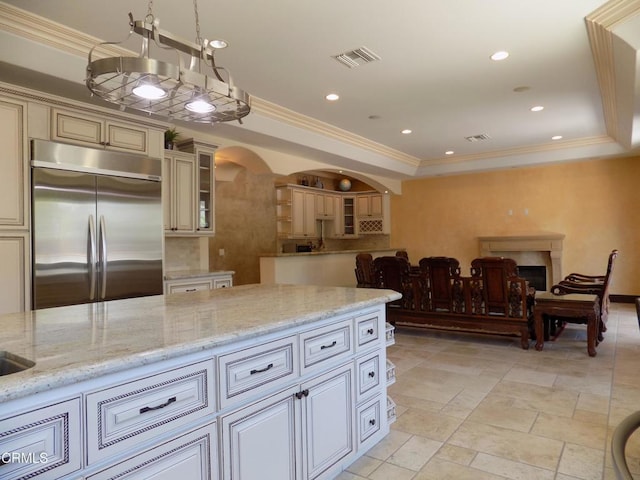 4526 Katherine Ave, Sherman Oaks, CA 91423 - kitchen with stainless steel built in refrigerator, arched walkways, open floor plan, light stone counters, and recessed lighting
