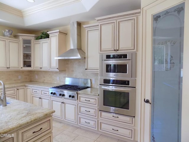 4526 Katherine Ave, Sherman Oaks, CA 91423 - kitchen with wall chimney exhaust hood, ornamental molding, cream cabinets, and backsplash