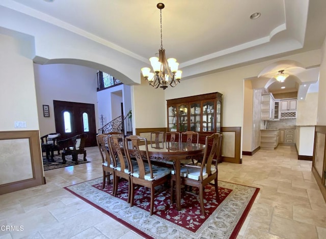 4526 Katherine Ave, Sherman Oaks, CA 91423 - dining area with stone tile floors, arched walkways, a chandelier, and stairway