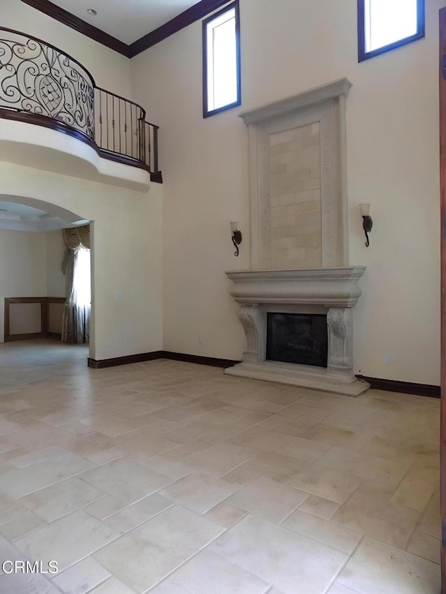 4526 Katherine Ave, Sherman Oaks, CA 91423 - unfurnished living room featuring a high ceiling, arched walkways, a premium fireplace, and crown molding