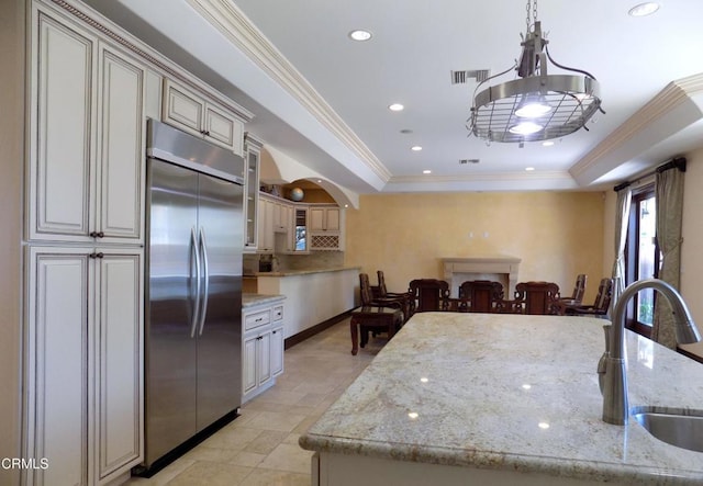 4526 Katherine Ave, Sherman Oaks, CA 91423 - kitchen featuring built in fridge, a tray ceiling, crown molding, a chandelier, and decorative backsplash